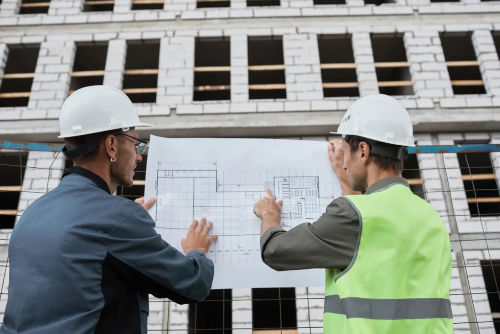 Rimberio builders reviewing blueprints together